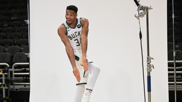 Giannis Antetokounmpo points to his Nike Zoom Freak 4 shoes.